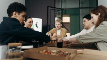 People eating pizza in the office