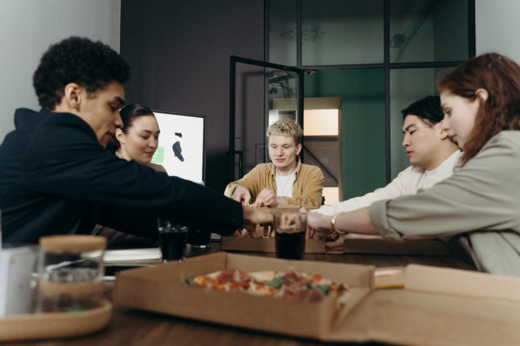People eating pizza in the office