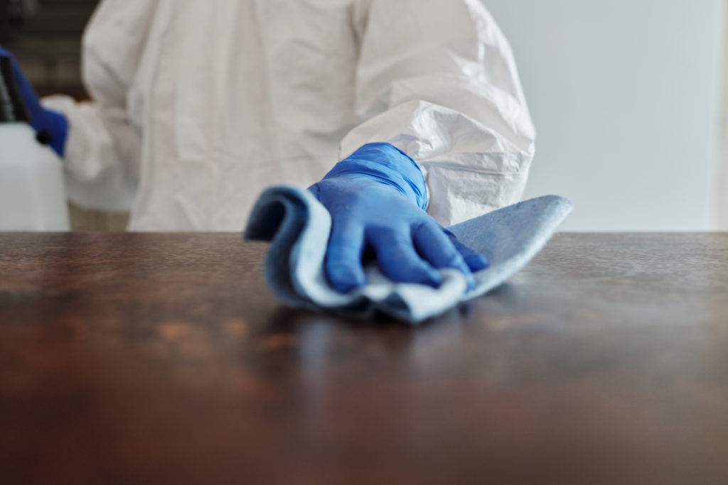 Close up photo of person cleaning the table