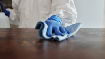 Close up photo of person cleaning the table